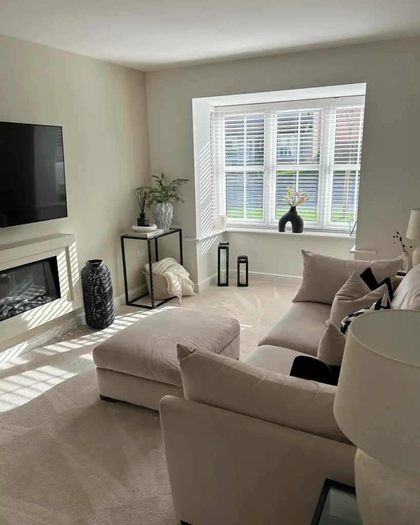 10. Beige Living Room with Bay Window and Black Accents