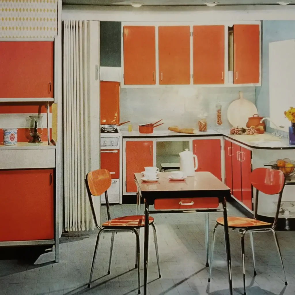 10. Bright Orange Kitchen with Chrome Bistro Chairs