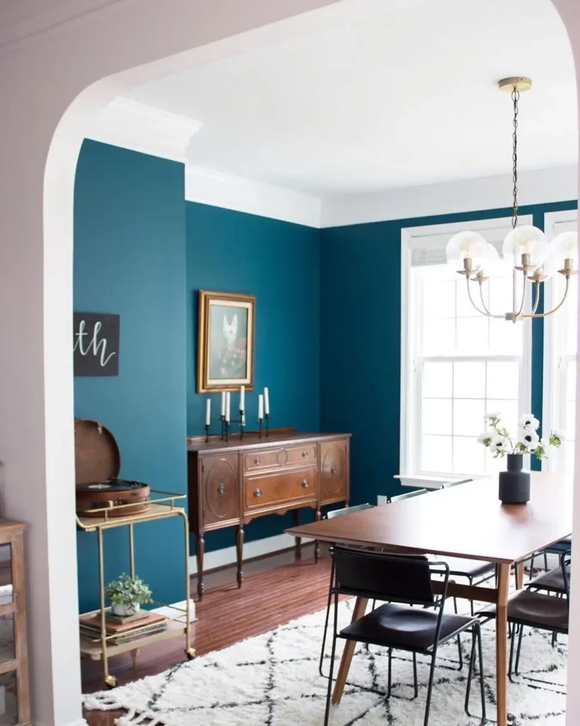 10. Teal Walls with Antique Wood Sideboard