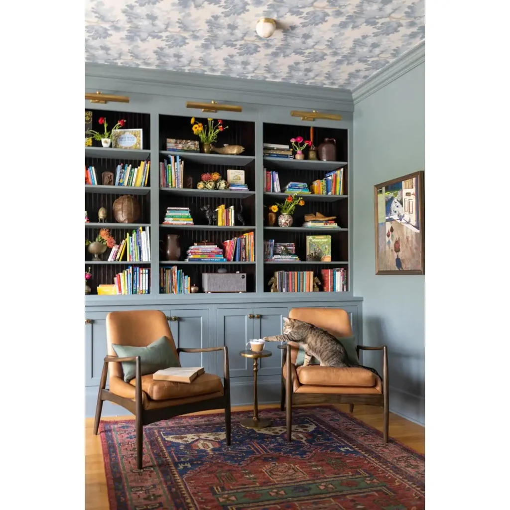 11. Dusty Blue Bookcase with Mid Century Leather Chairs
