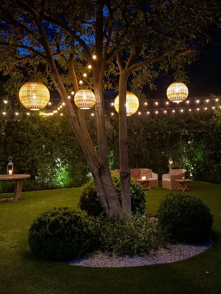 2. Rattan Globe Lanterns Hanging From A Tree