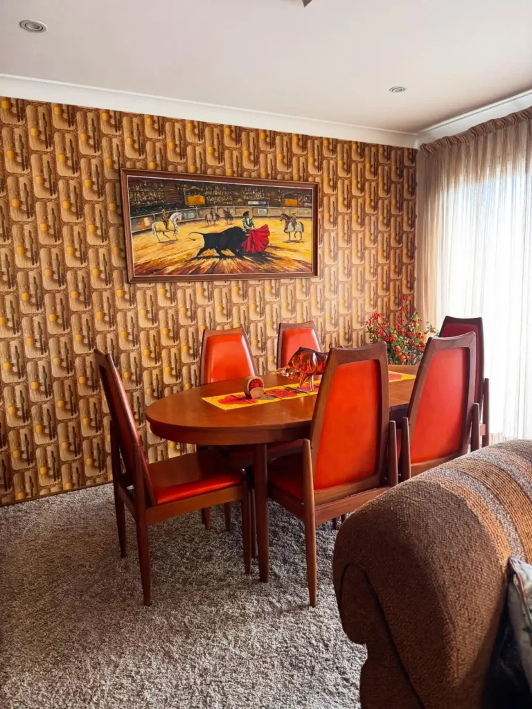 4. Patterned Wallpaper Dining Room with Orange Chairs