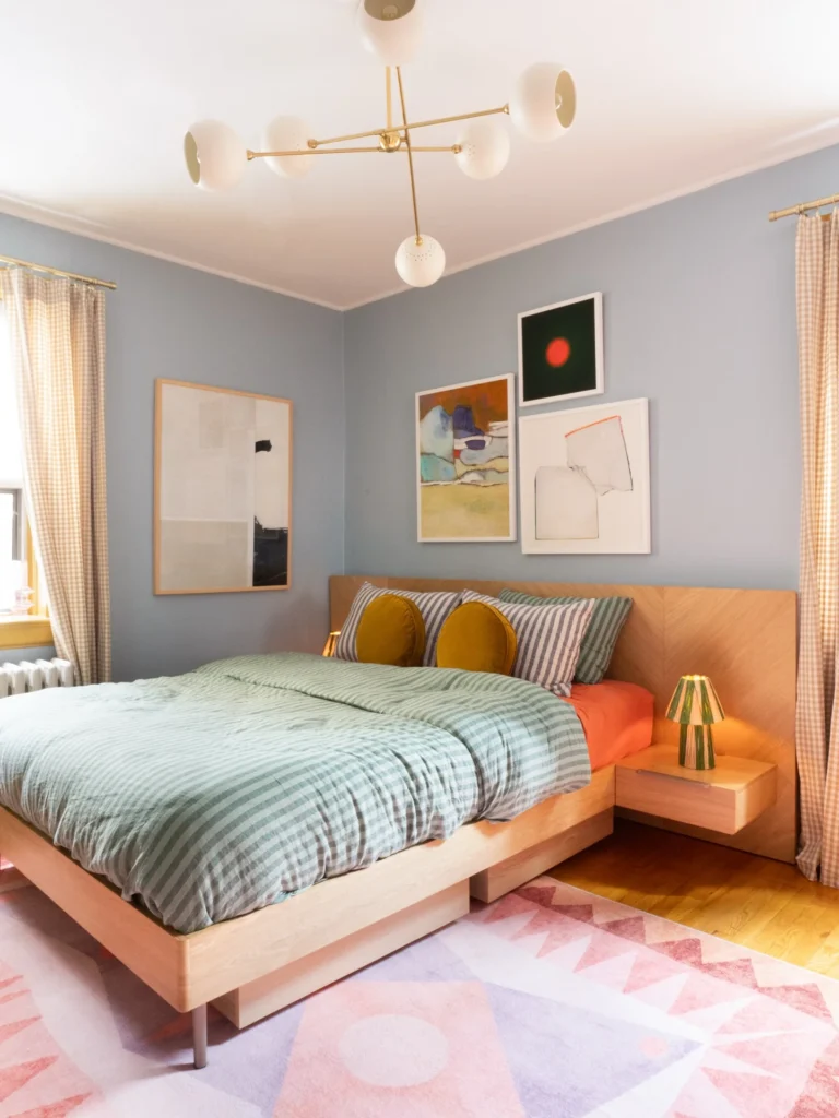5. Blue Walled Bedroom with a Modern Art Gallery