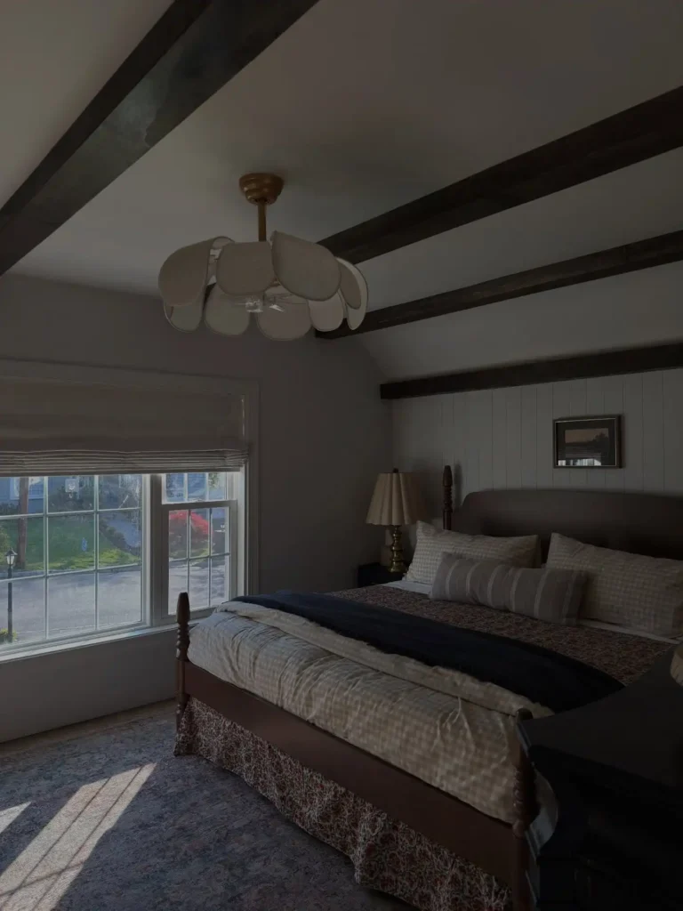 6. Beamed Bedroom with a Petal Style Ceiling Light