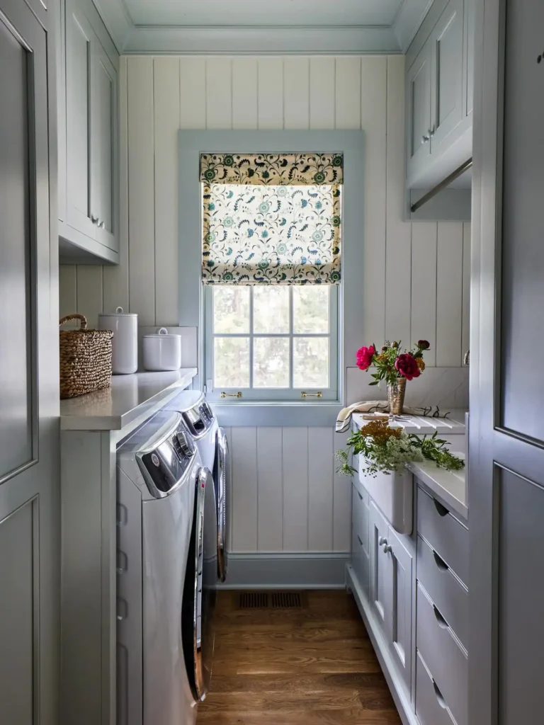 6. Galley Style Laundry Room With Floral Roman Shade