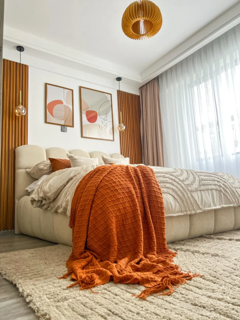 8. Curved Cream Bed with a Wood Pendant Light