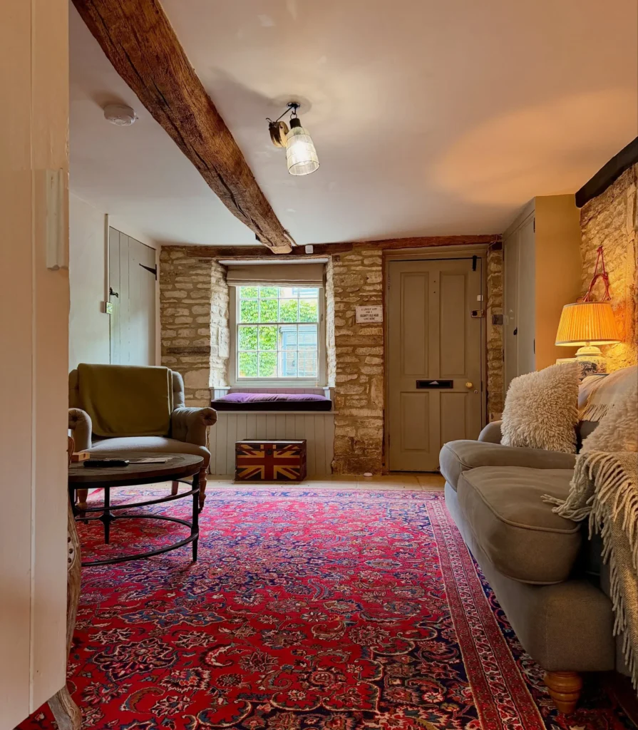 8. Stone Wall Entryway with a Bold Persian Rug