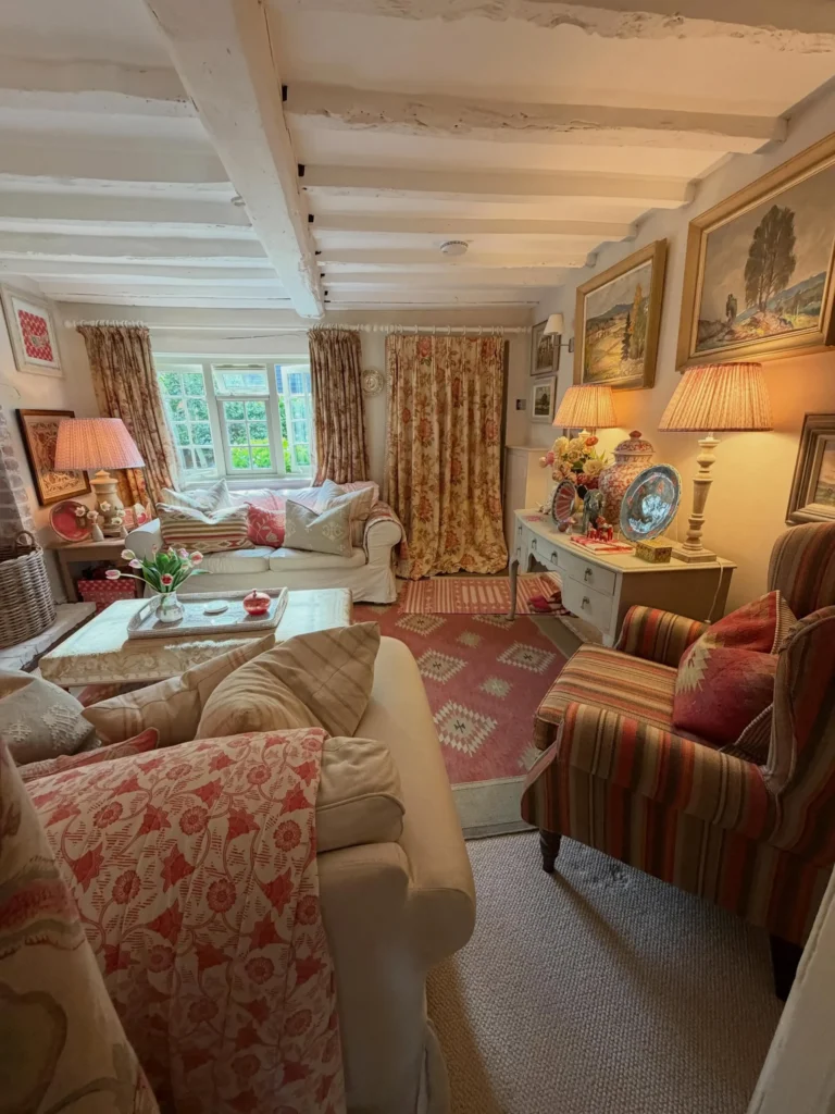 9. Layered Floral Cottage Living Room with Vintage Curtains