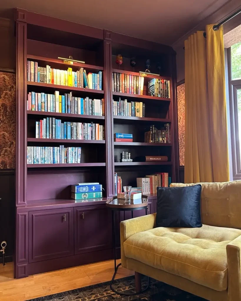 9. Plum Bookcase with a Mustard Velvet Chair