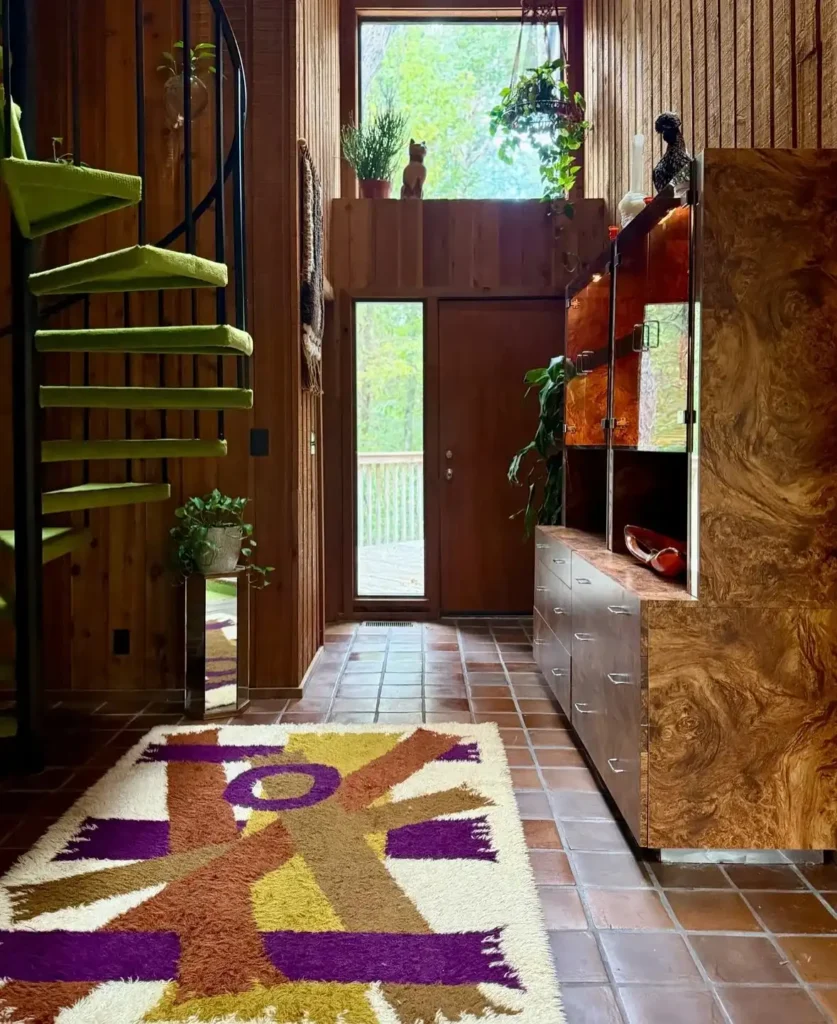 9. Wood Paneled Entryway with a Green Spiral Staircase