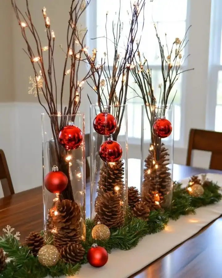 10. Lit Branch Vases with Hanging Ornaments and Pinecones