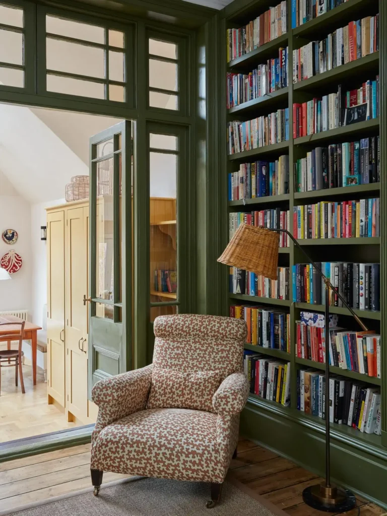 14 Cozy Living Room Reading Corners Built Around One Armchair 11 10. Patterned Armchair in a Green Paneled Library