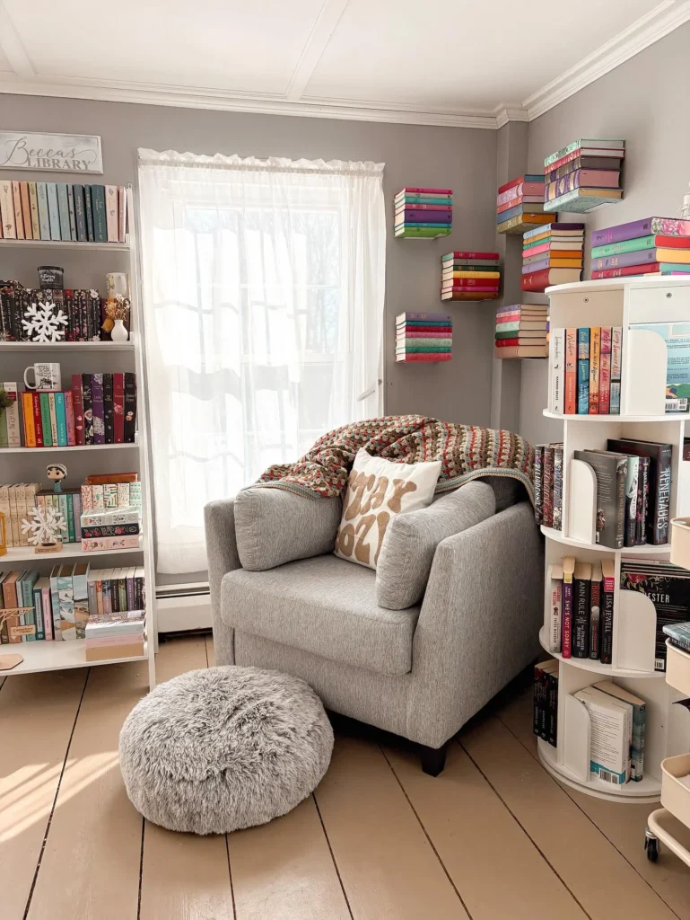 14 Cozy Living Room Reading Corners Built Around One Armchair 12 11. Grey Armchair Beside a Rotating Book Tower