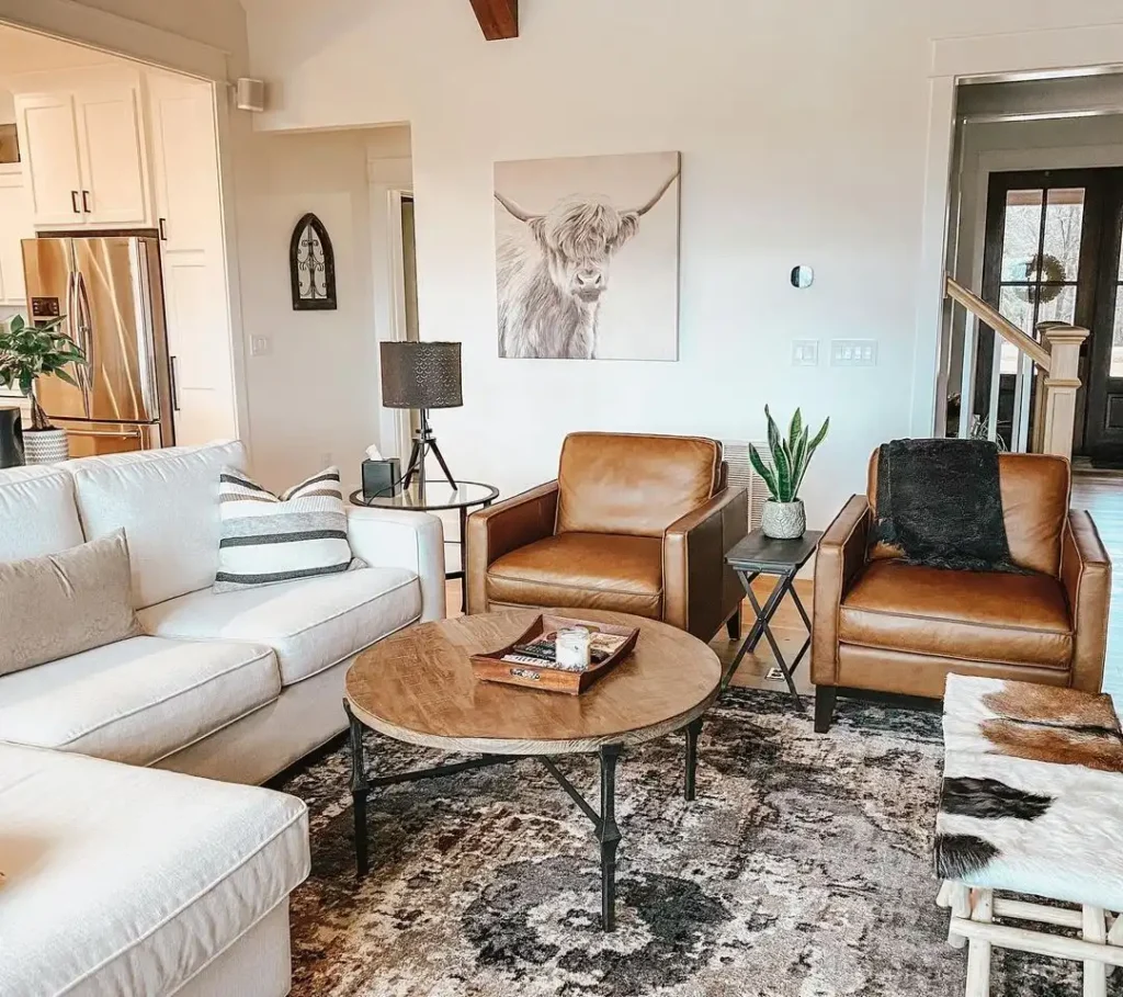 2. Tan Leather Chairs With Highland Cow Art