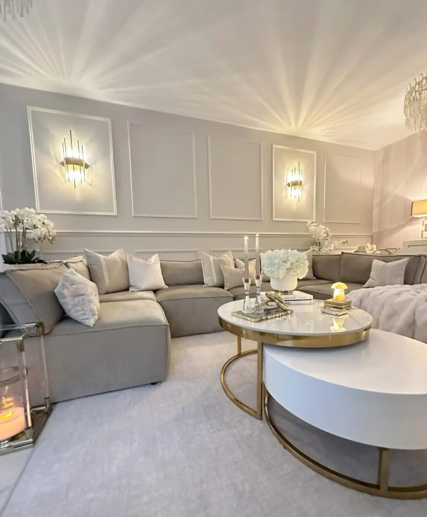 7. Glam Beige Living Room With Gold Accents And Sconces